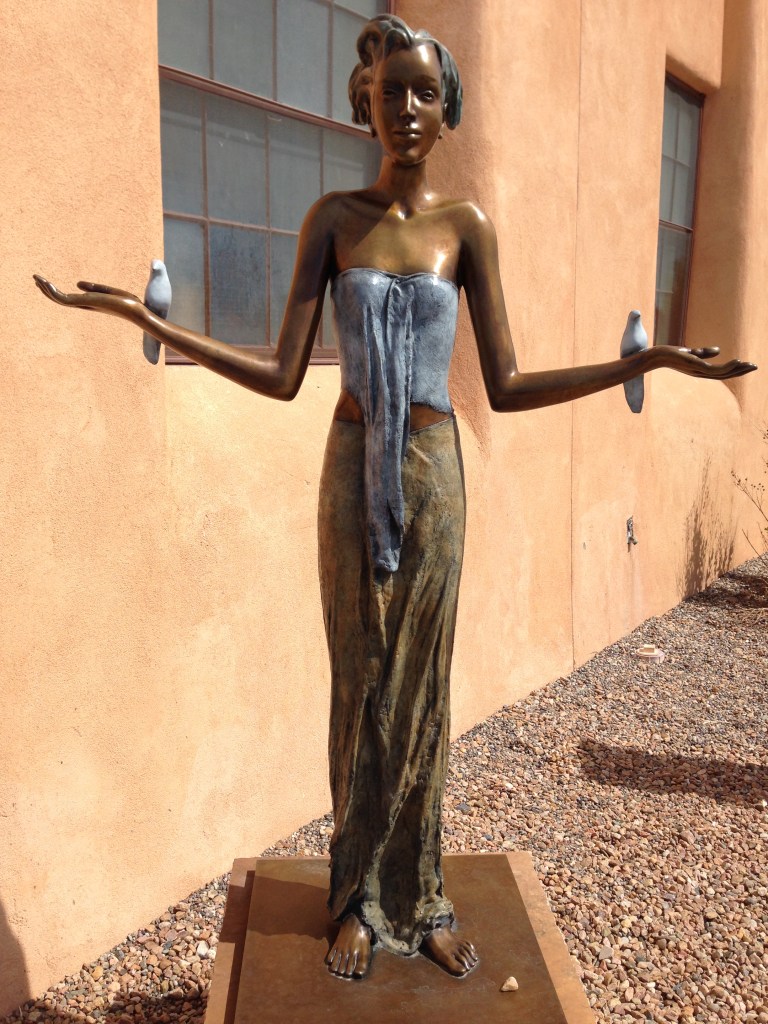 statue of a young woman with outstretched arms 