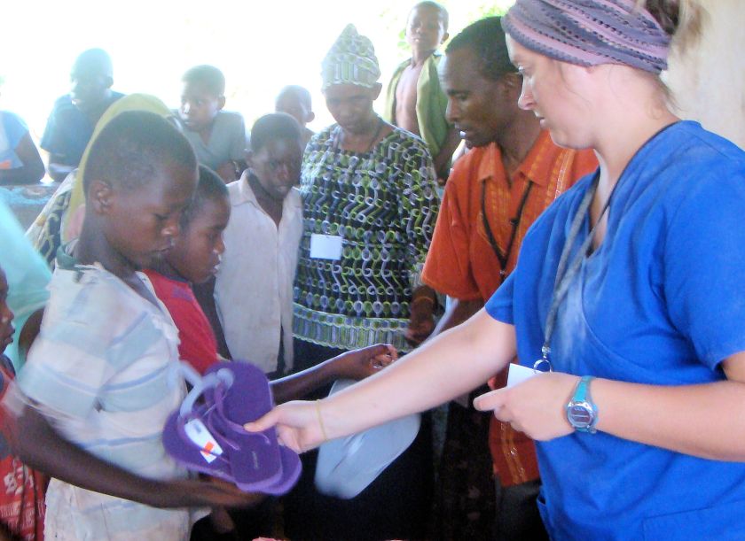 nurse with boy giving shoes