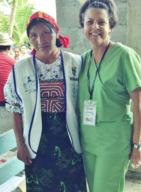 two health care professionals, one in a native costume