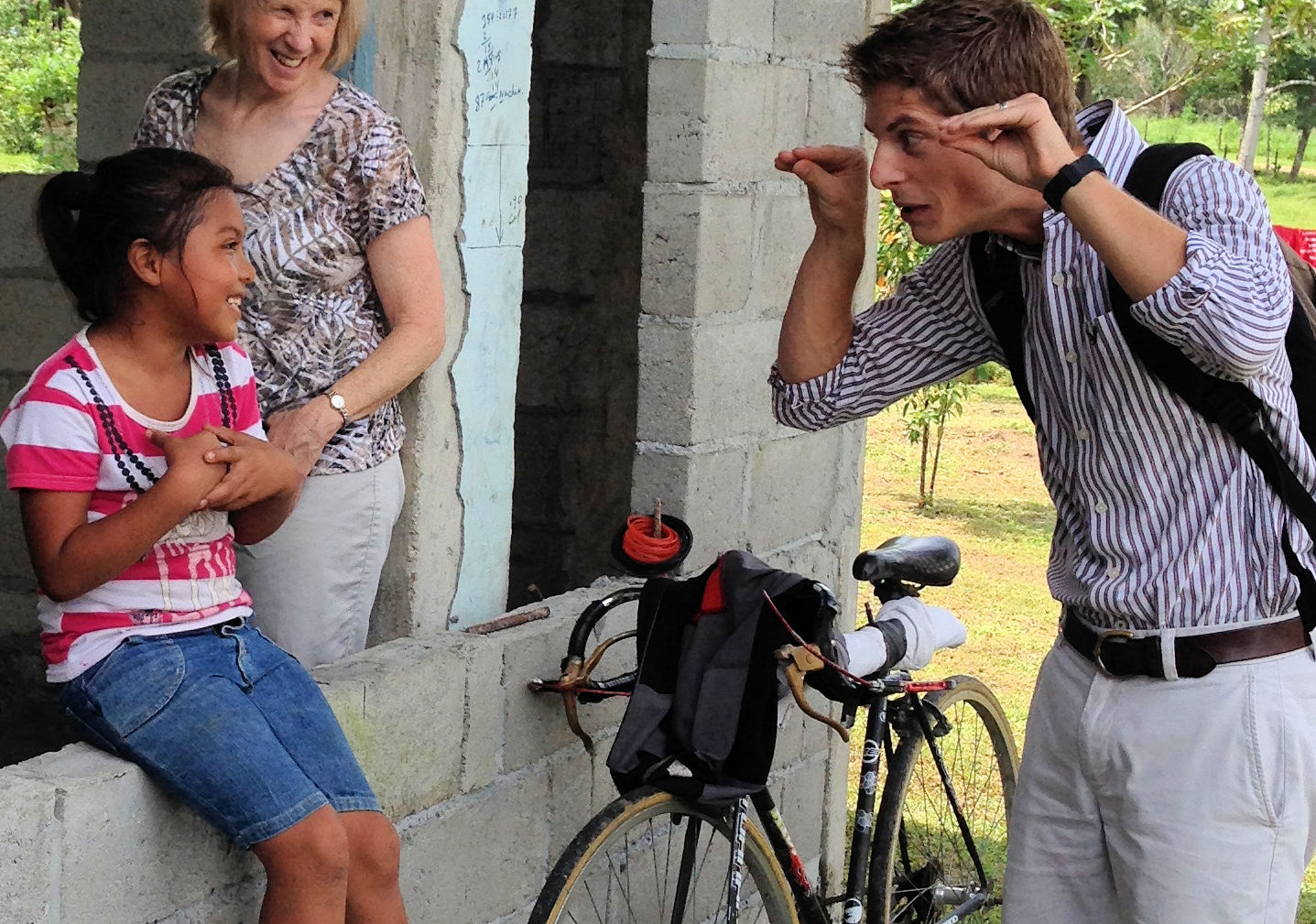 a man making faces at a little girl