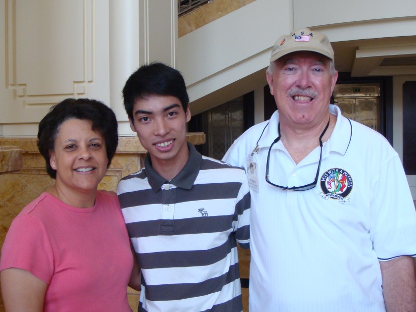 3 people, a man and wife with a young man