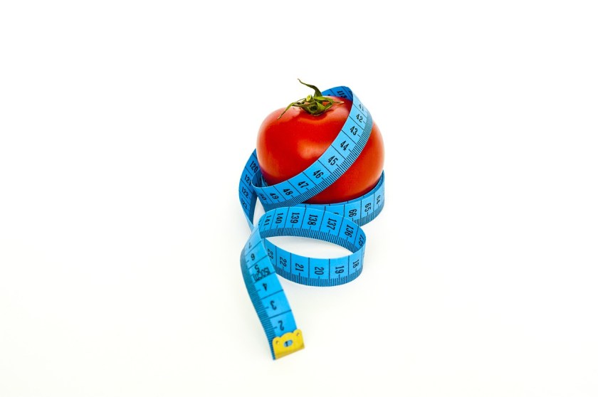 a tape measure wrapped around an apple
