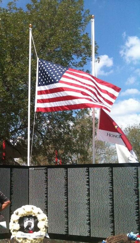 American flag waving at a Vietnam Veterans Wall replica
