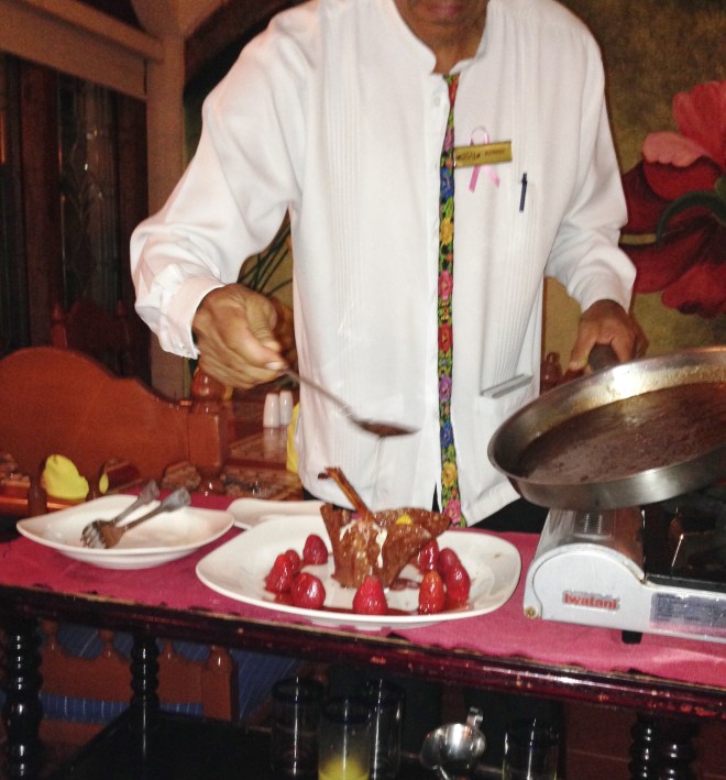 watching our waiter preparing a flaming strawberry dessert 