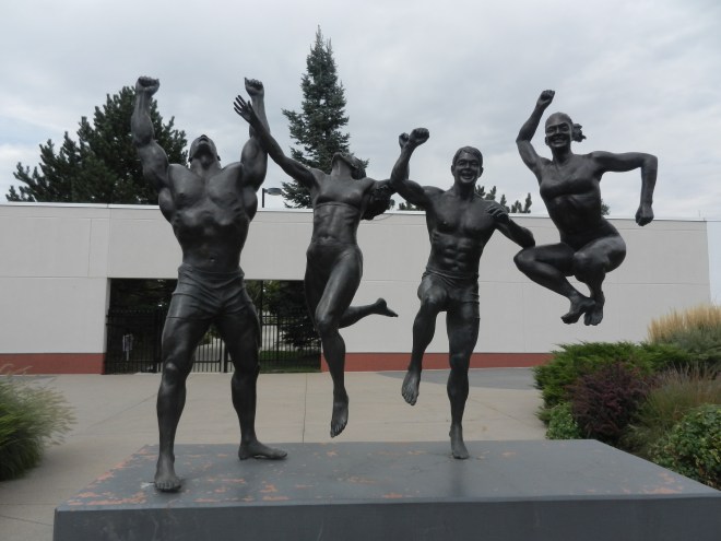 statue of athletes at entrance to facility 