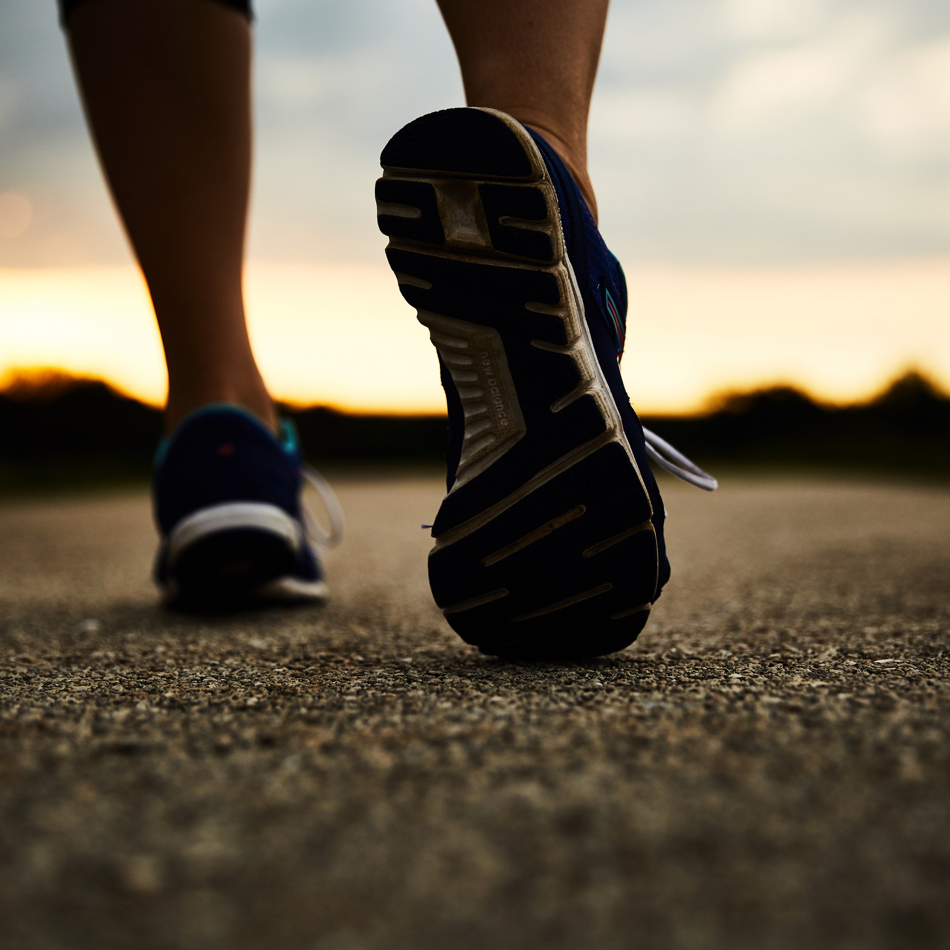 close up of walking down a road in sports shoes