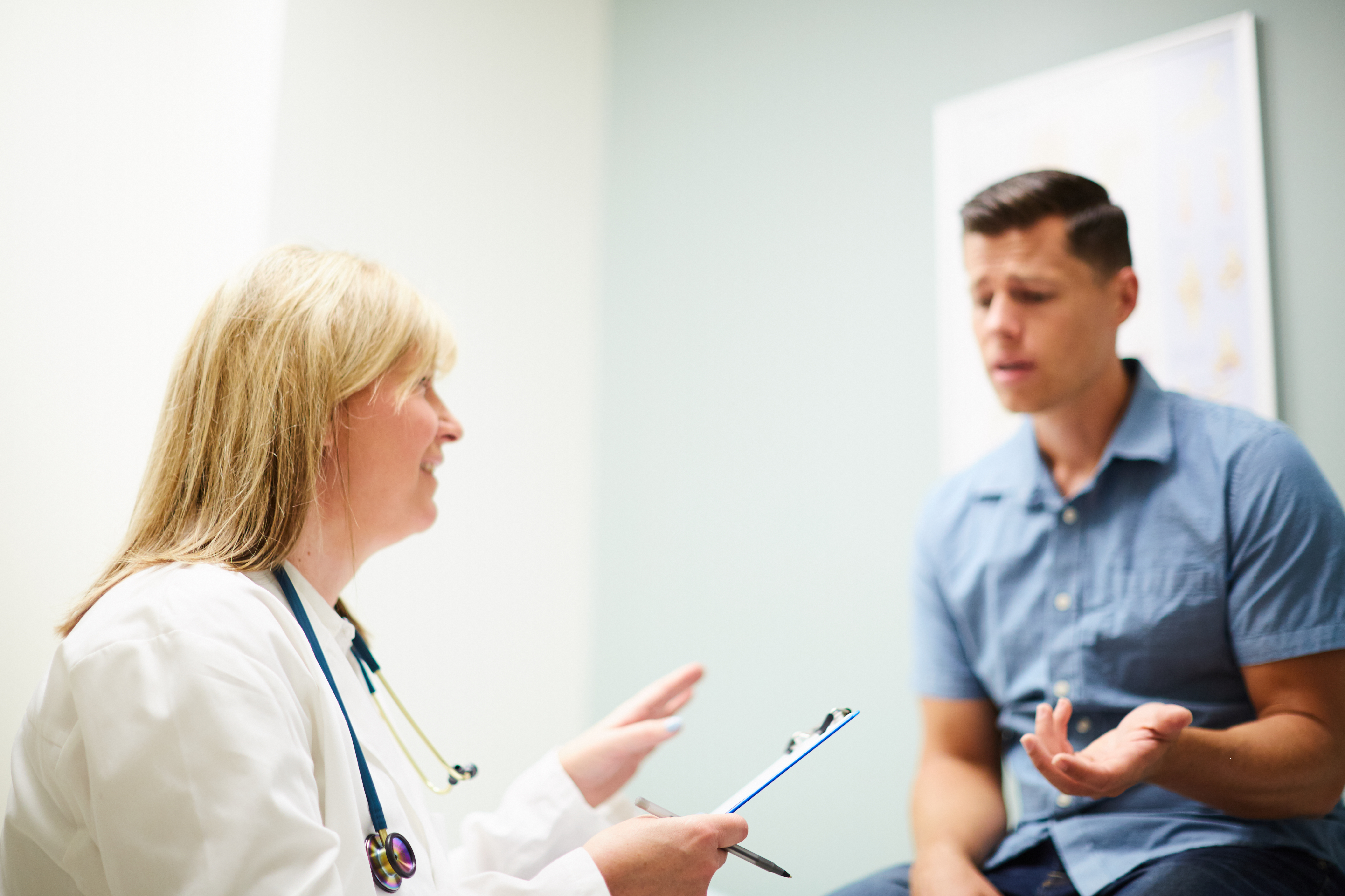 a female physician talking to a male patient