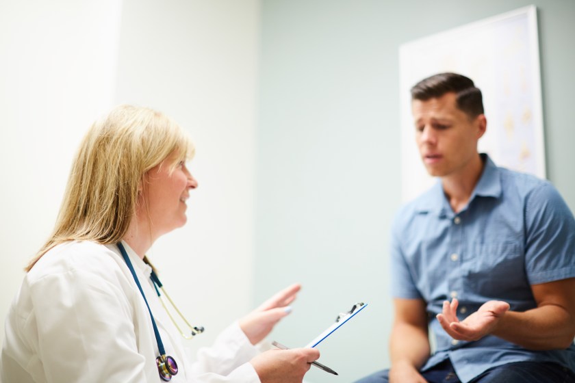 a female physician talking to a male patient
