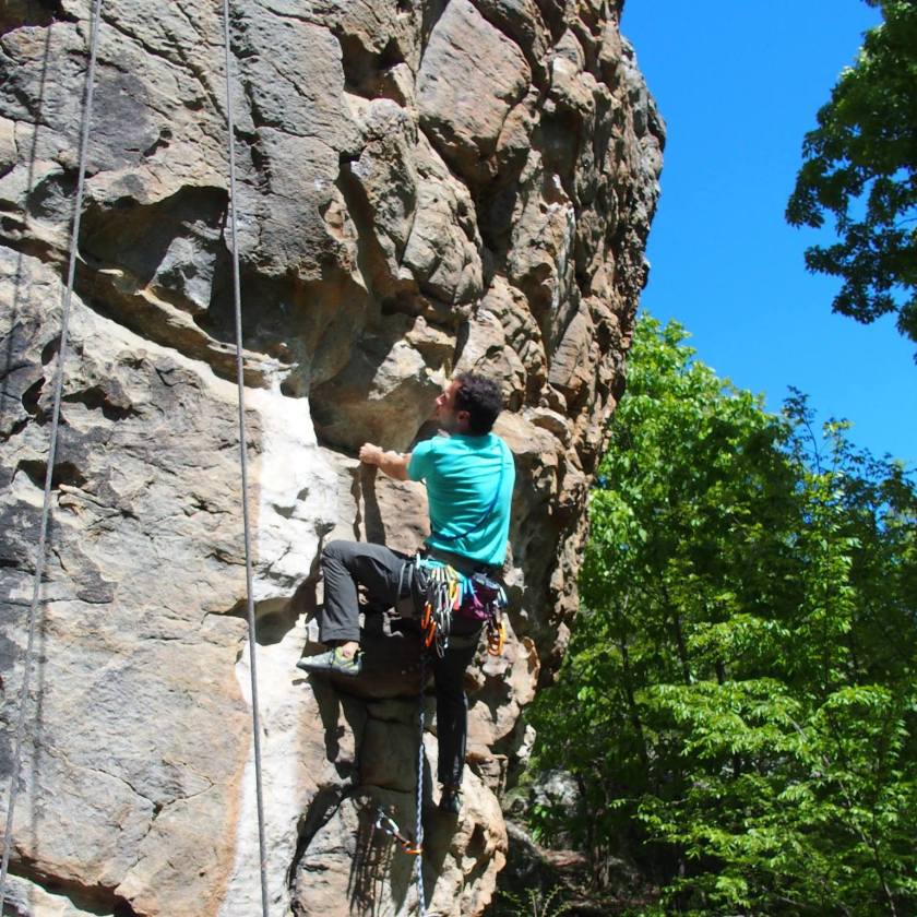 Man climbing up a rock wall