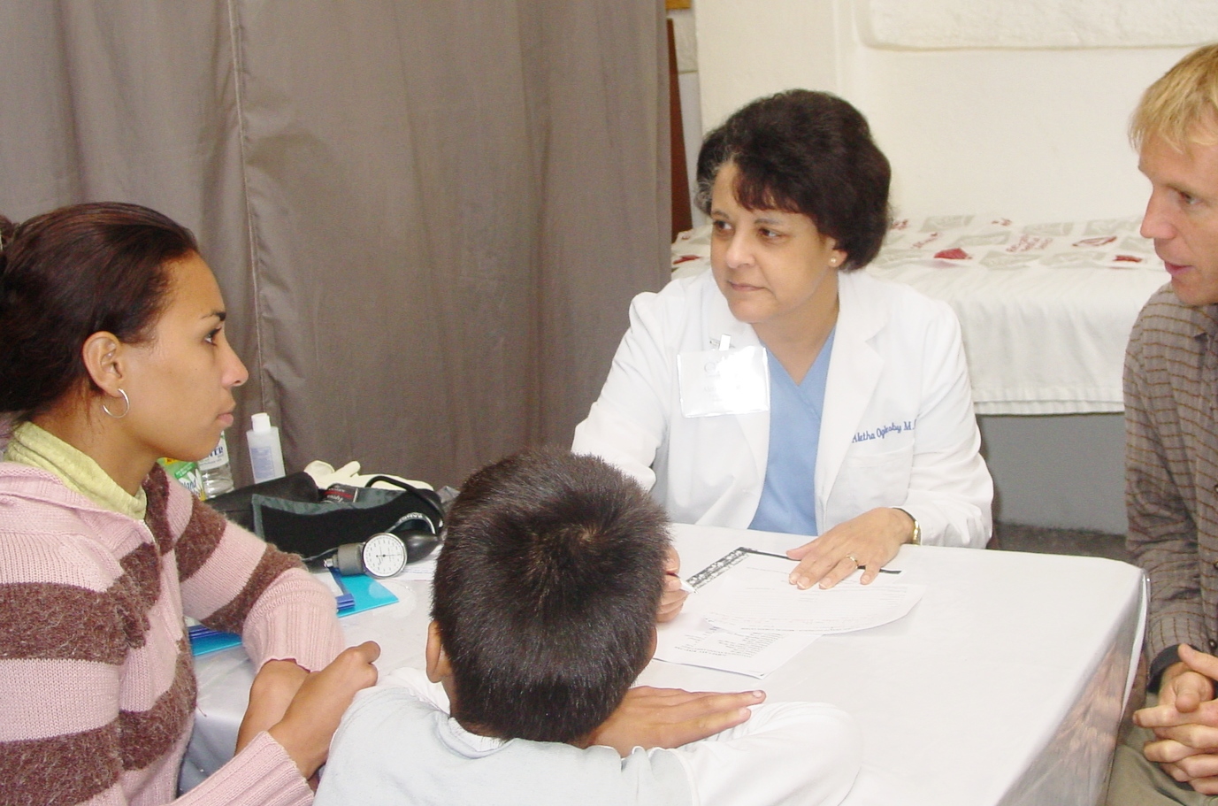 Dr. Aletha talking to a mother and her son