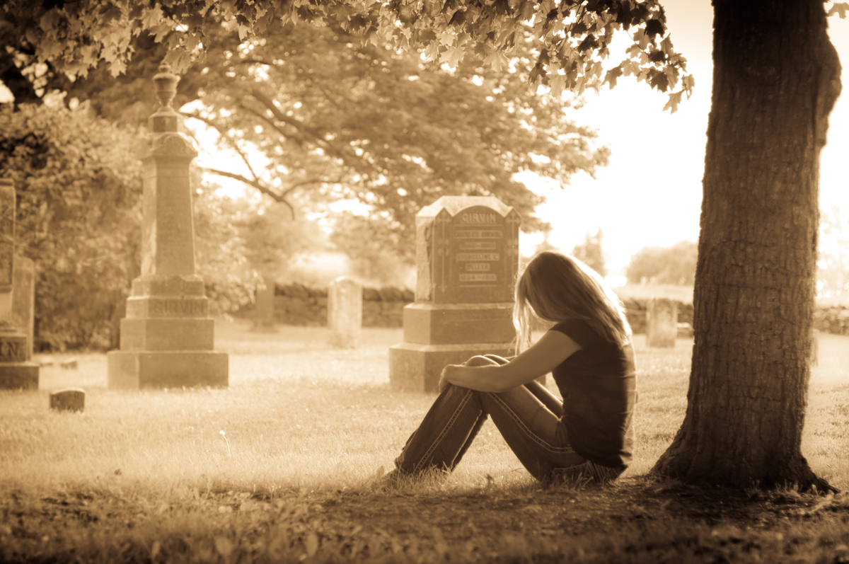 woman sitting in a cemetery