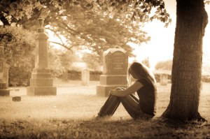 woman sitting in a cemetery