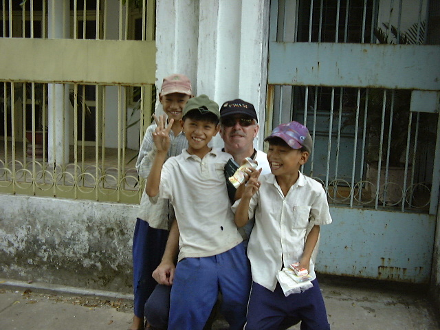 man with Vietnamese boys laughing