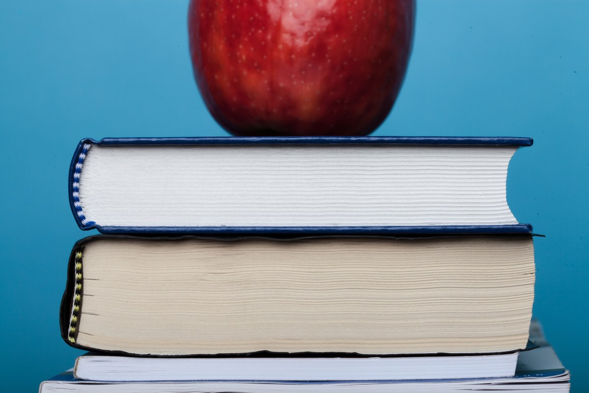 an apple on top of a stack of books