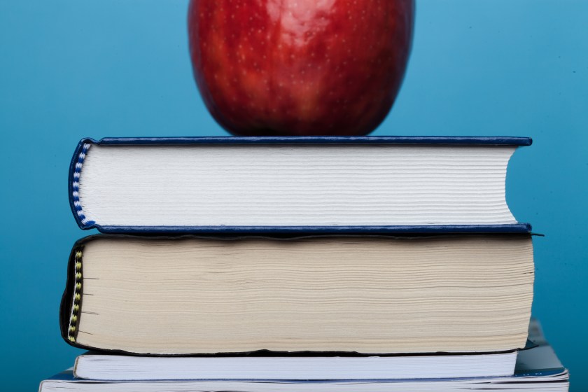 an apple on top of a stack of books