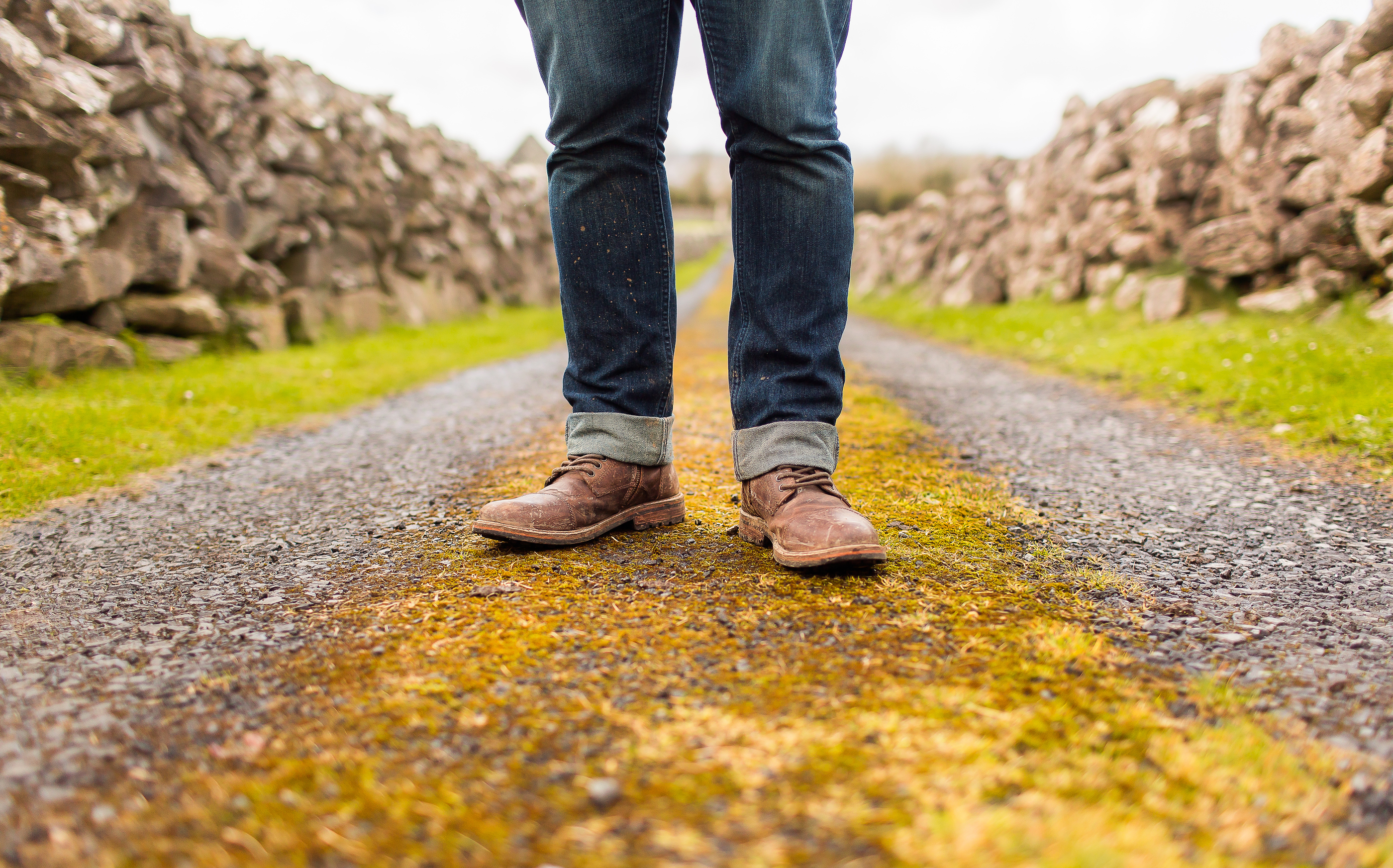 man in jeans standing in a path
