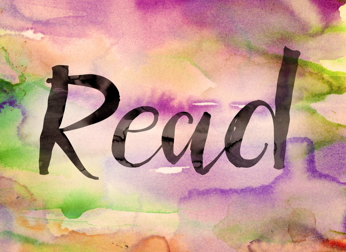 The word "Read" written in black paint on a colorful watercolor washed background.