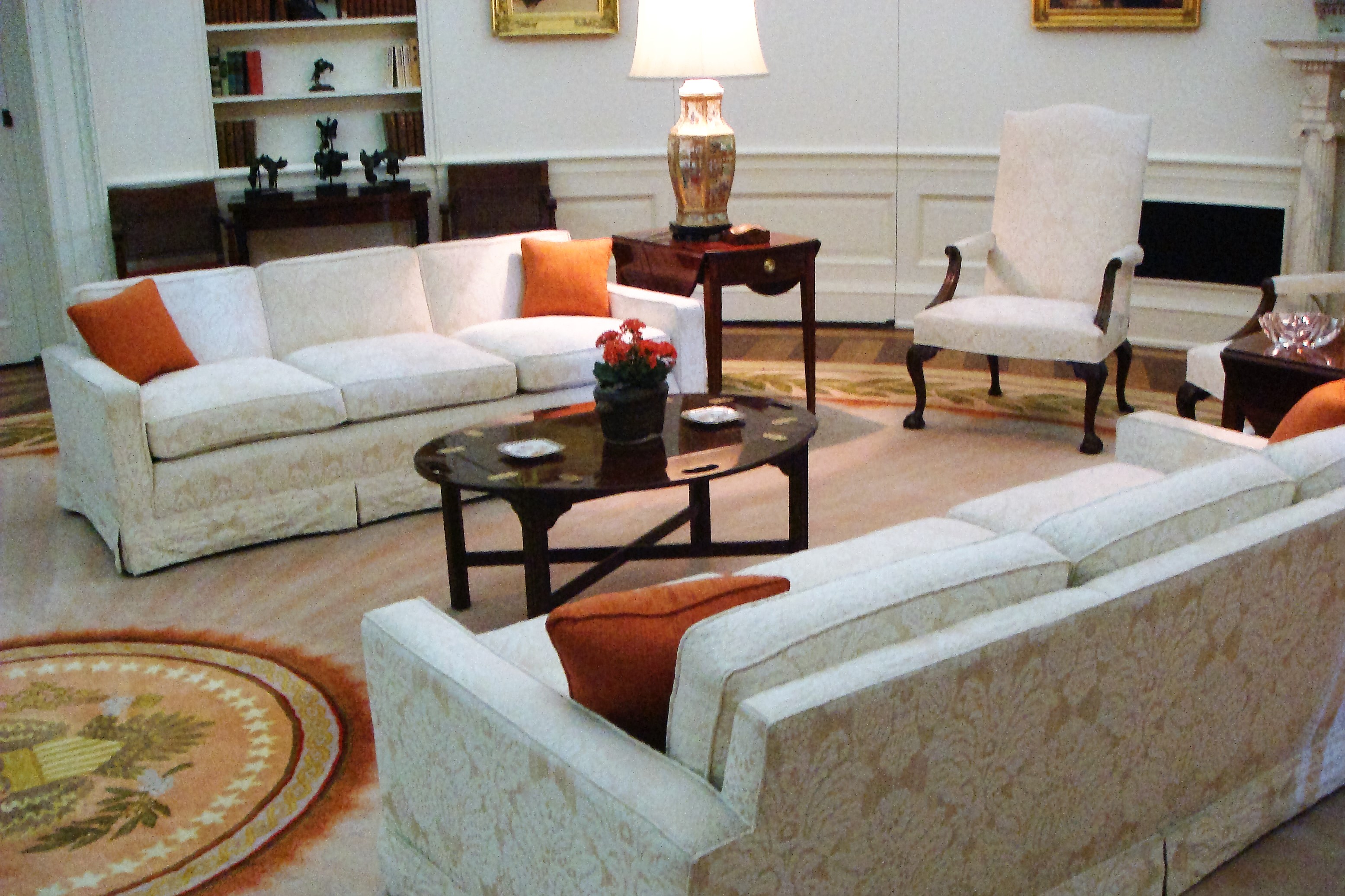 couches in room with Presidential seal on the floor