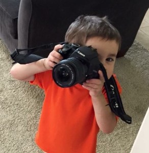 little boy with a big camera