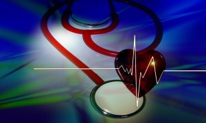 a stethoscope, a red heart and a heart ekg tracing