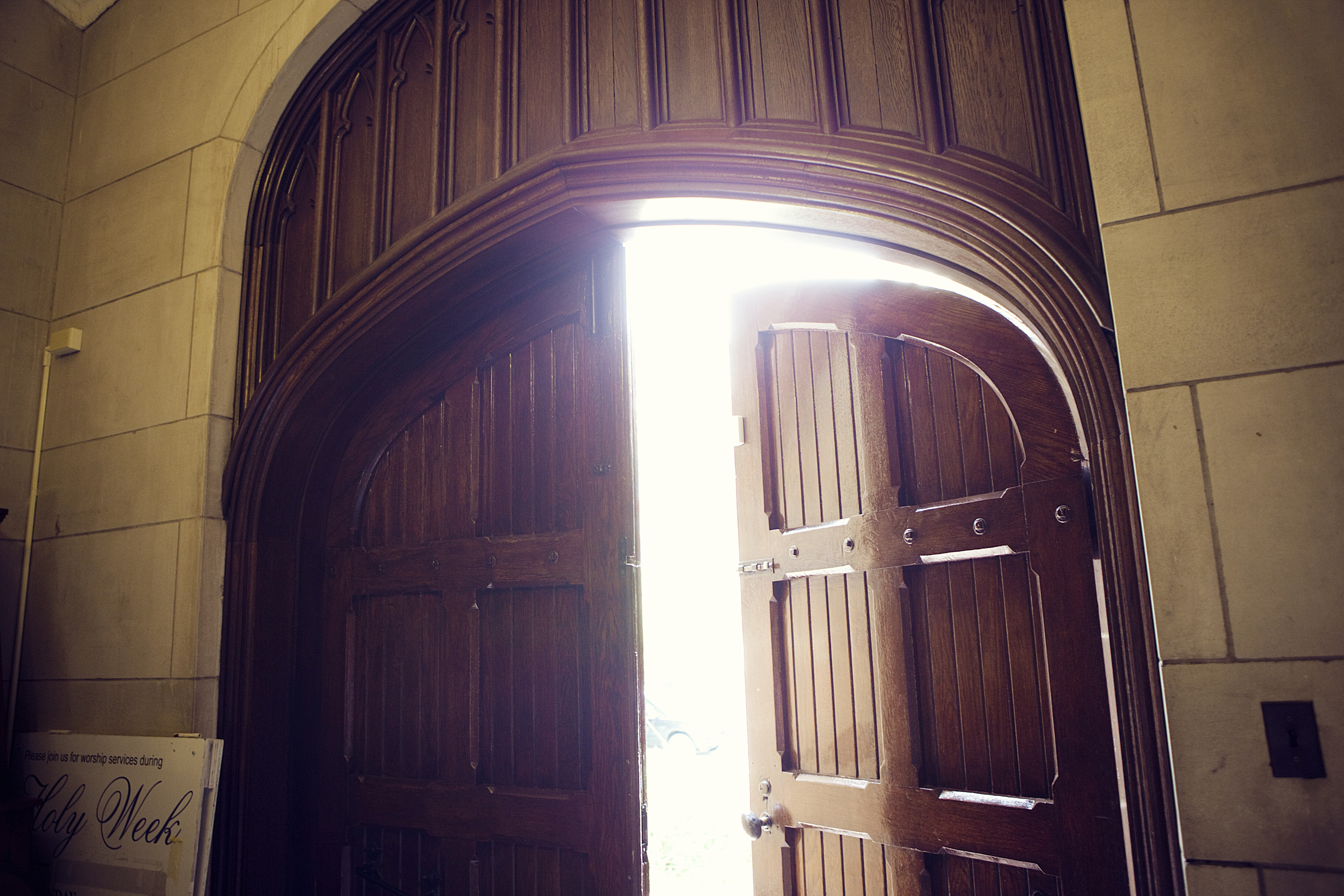 bright light shining through heavy wood doors