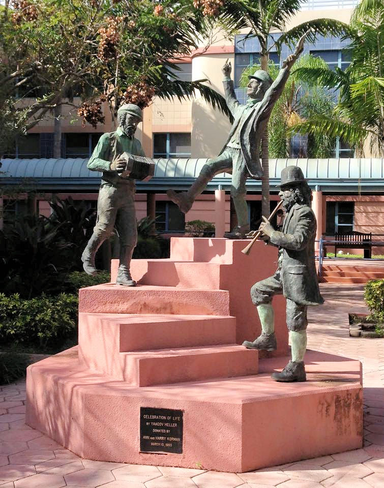 statue of 3 men dancing and playing instruments