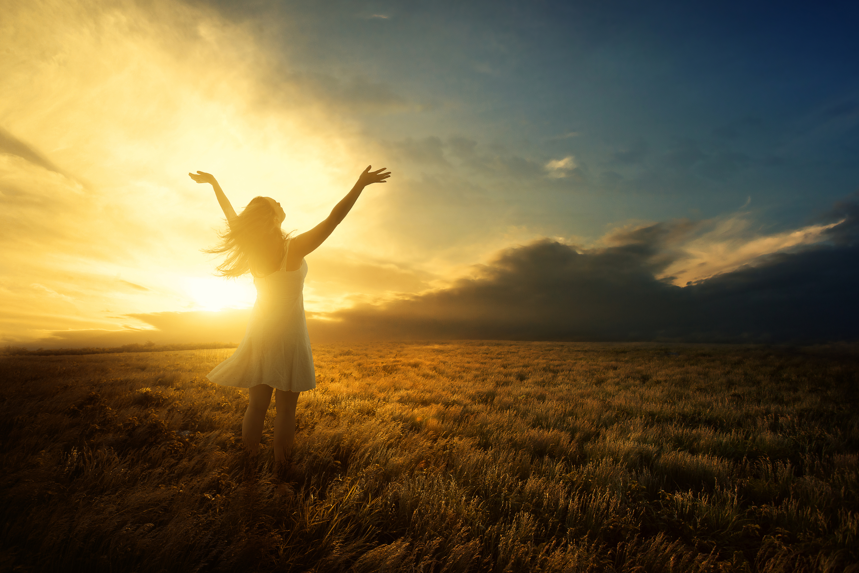 woman standing in a field with bright sunlight
