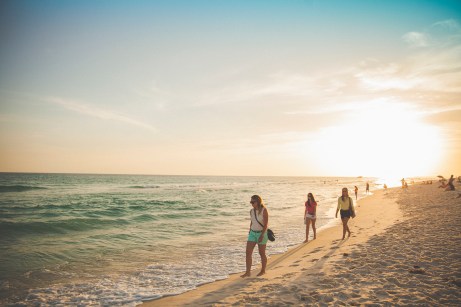 young women walking on a beach