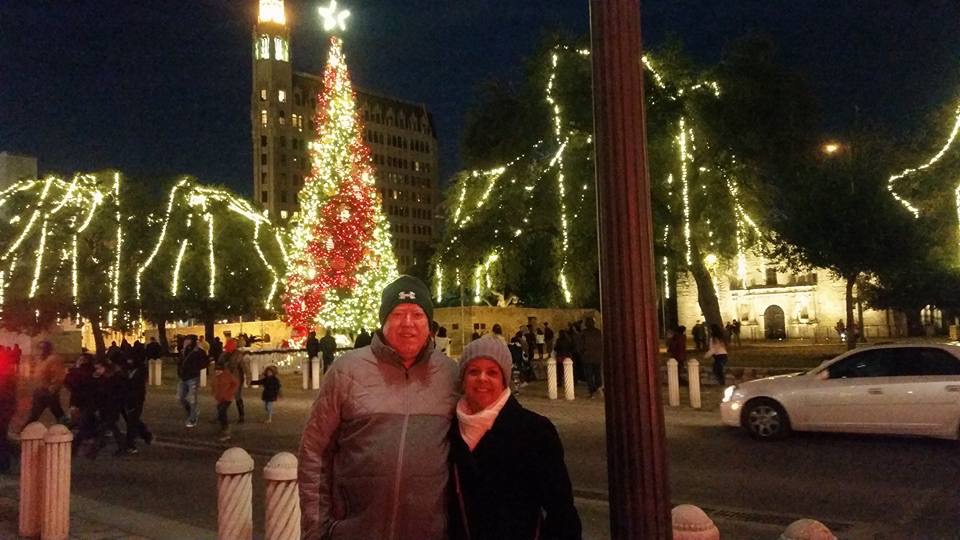 man and woman in front of the Alamo at Christmas