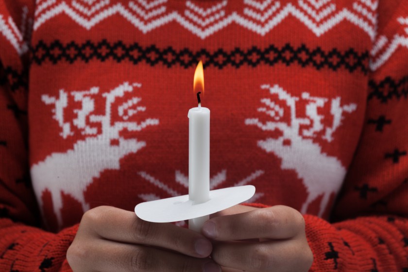 person holding a lit candle