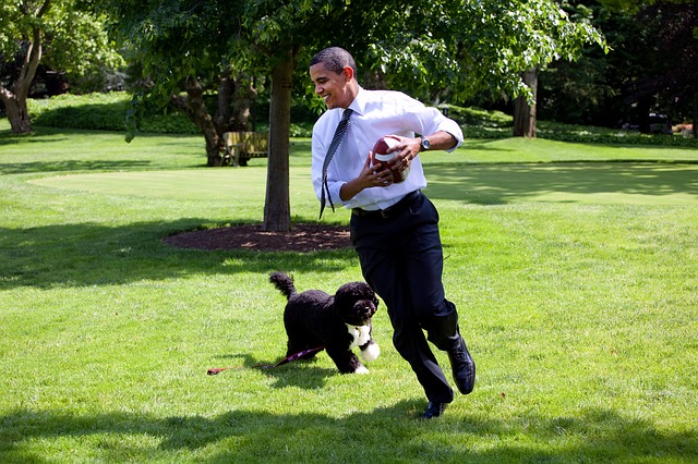 Former President Obama running with his dog