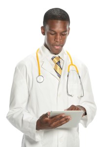 a male doctor holding a tablet