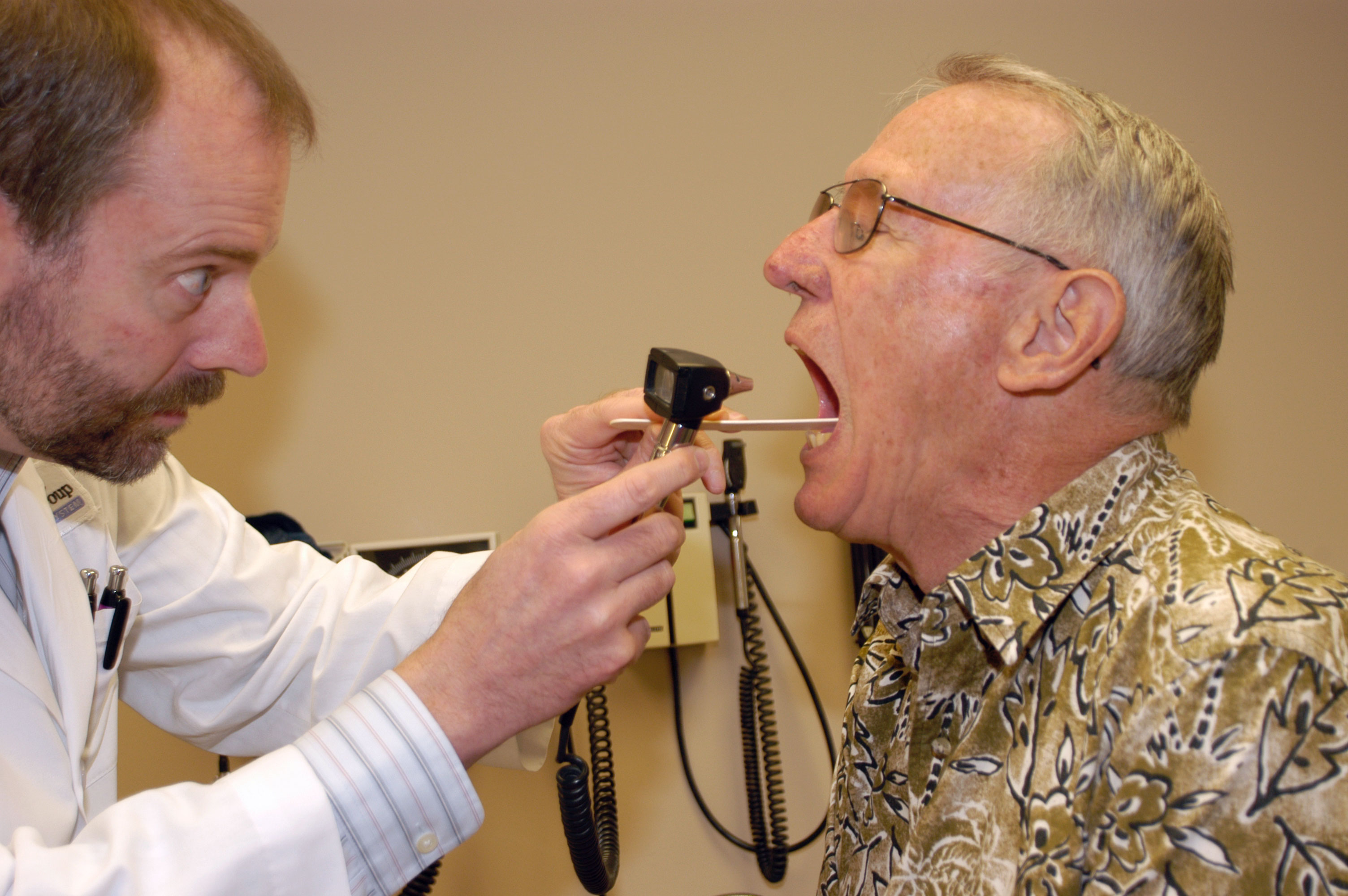 a doctor looking into a patient's mouth