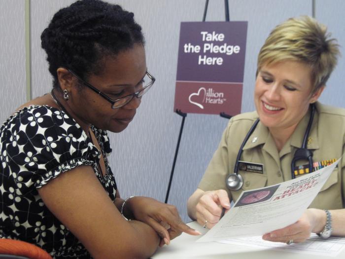 a nurse discussing blood pressure with a patient.