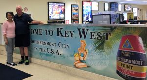 man and woman with Key West visitor sign