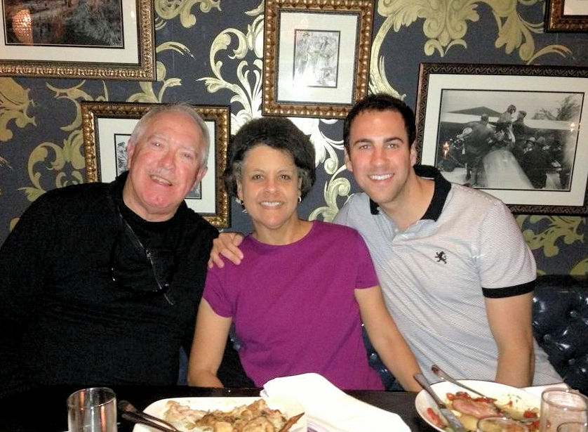 lady, 2 men posing together in a restaurant