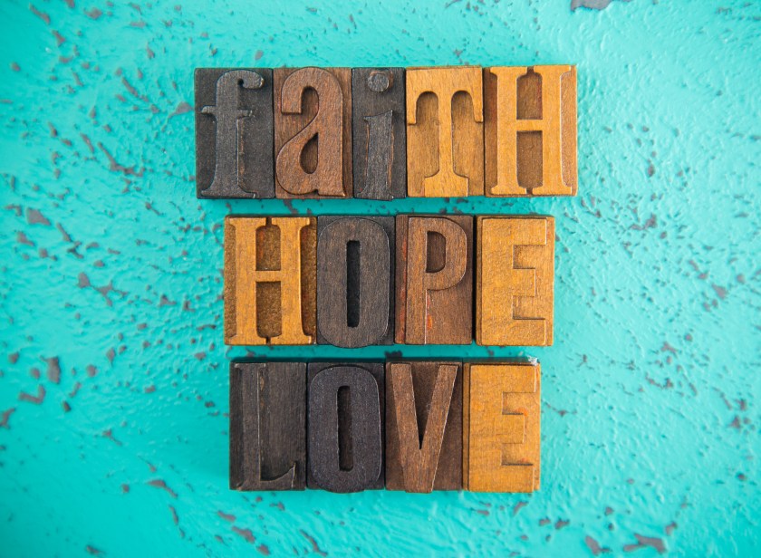 faith, hope, love spelled out in wooden block letters