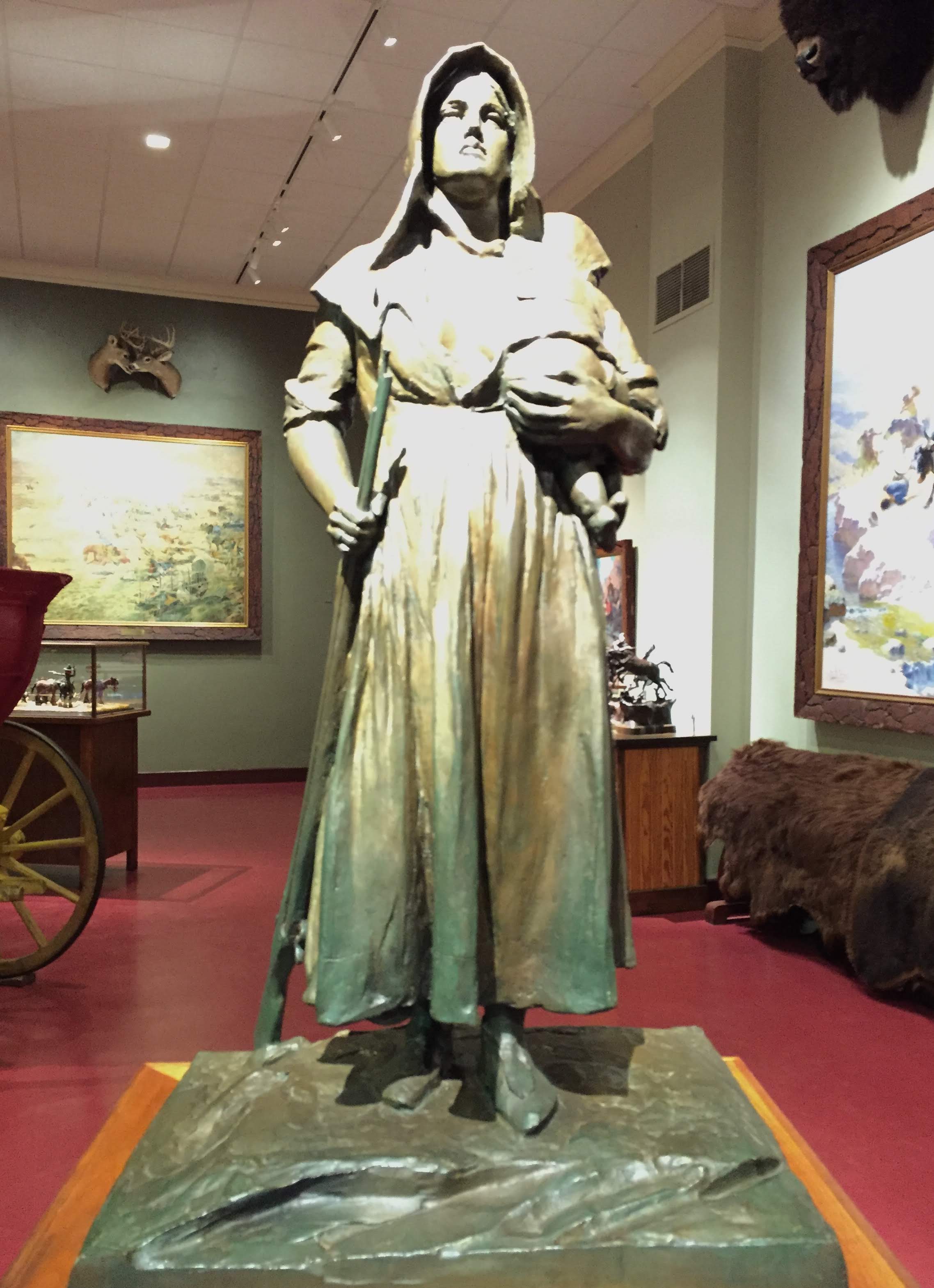 statue of a pioneer woman with rifle and infant