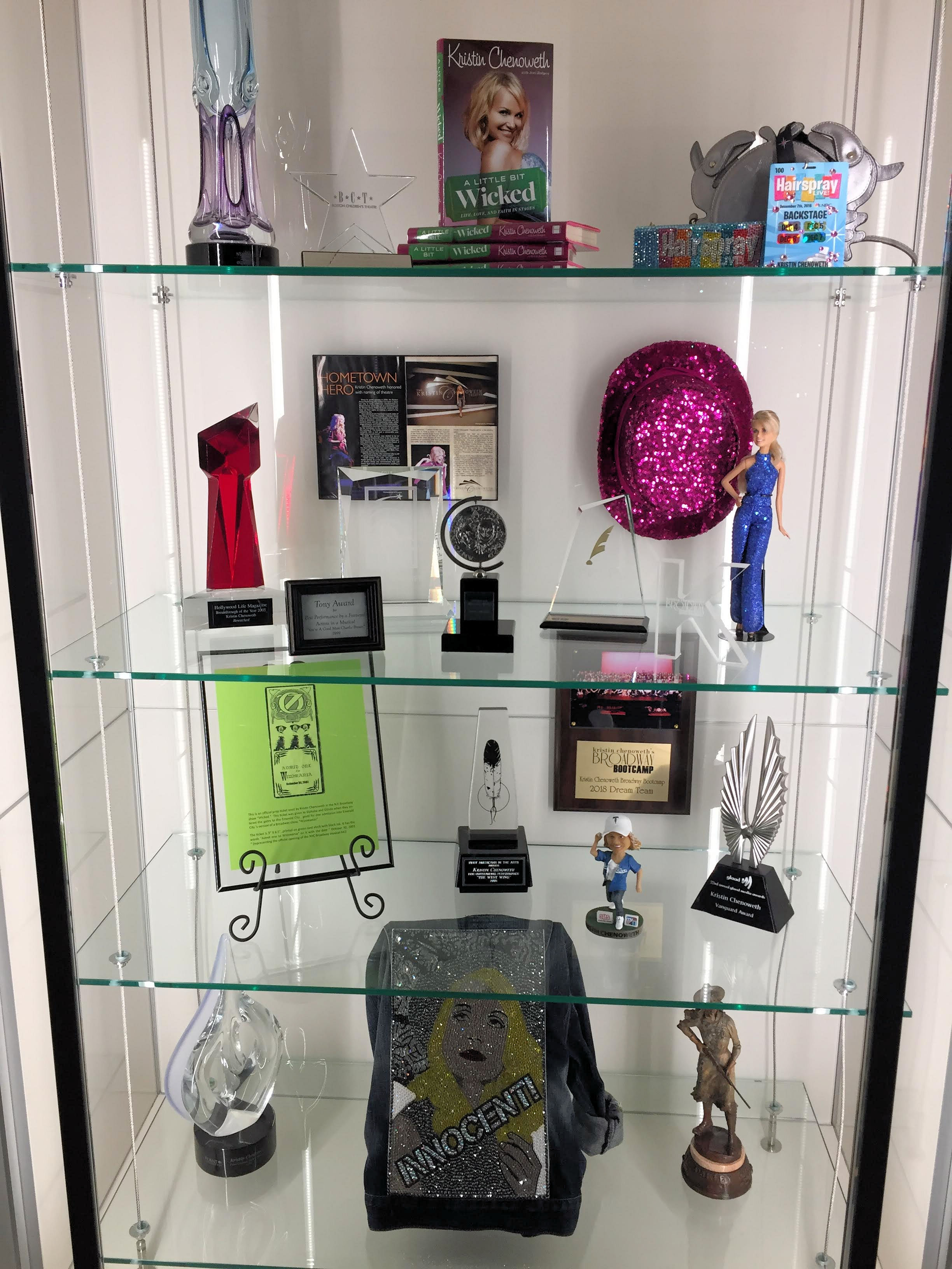 a display case with trophies belonging to Kristen Chenoweth