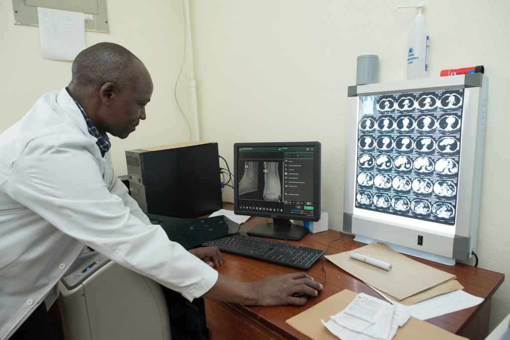 An African doctor viewing xrays and MRI image.