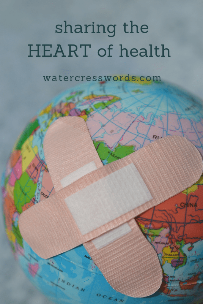 "sharing the HEART of health" written over a globe with two crossed bandaids
