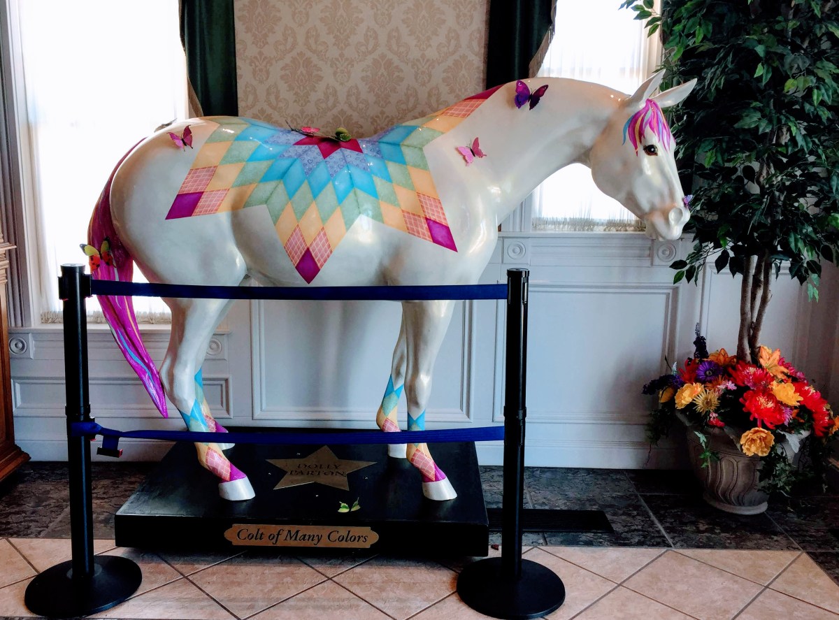 a horse statue, white with bright multicolored design