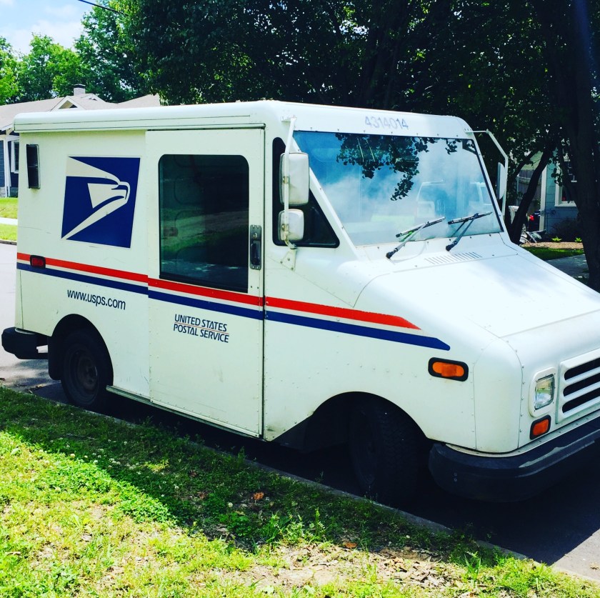 a USPS truck parked on a street