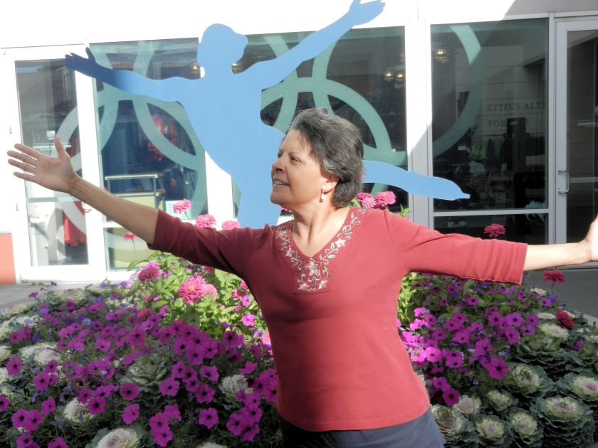 Dr Aletha lifting arms like an ice skater shadow behind her