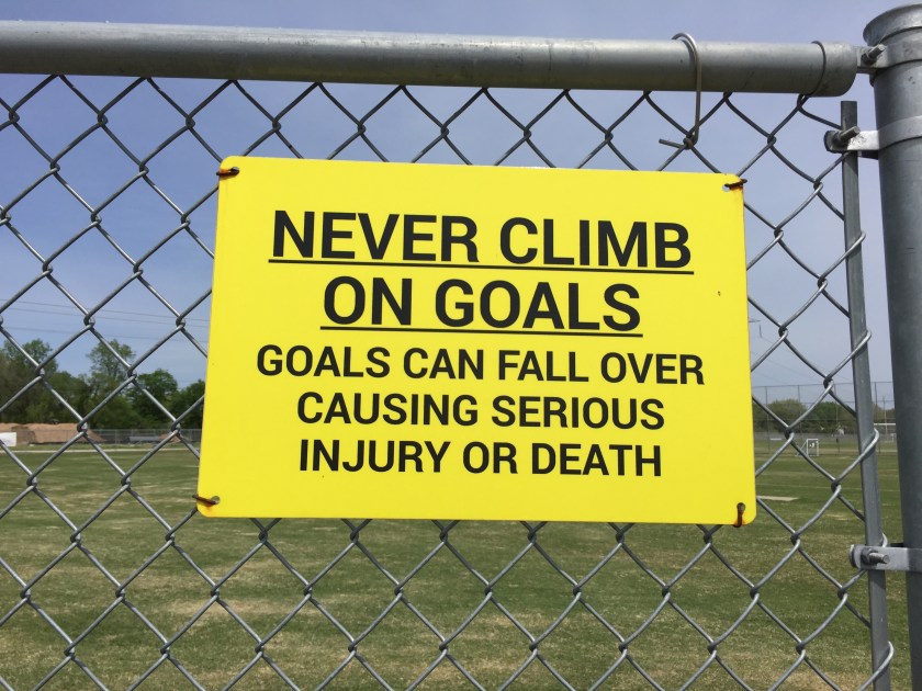 a sign says"never climb on goals"