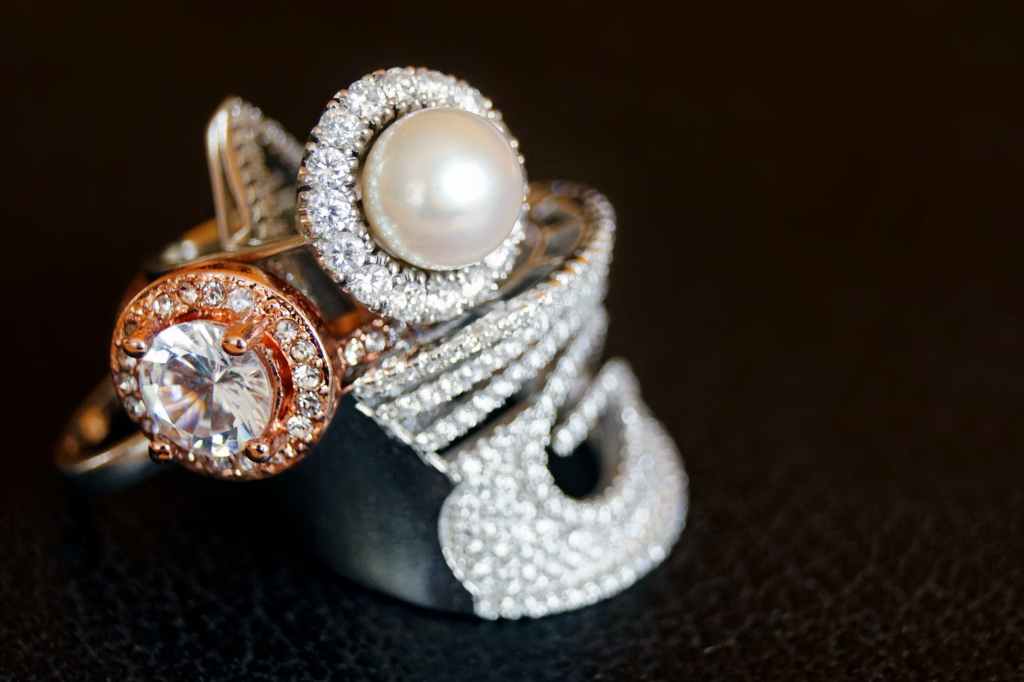 a white pearl ring with diamond highlights