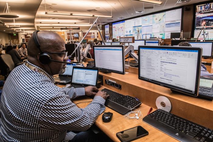 man sitting in front of computer monitor at the CDC.