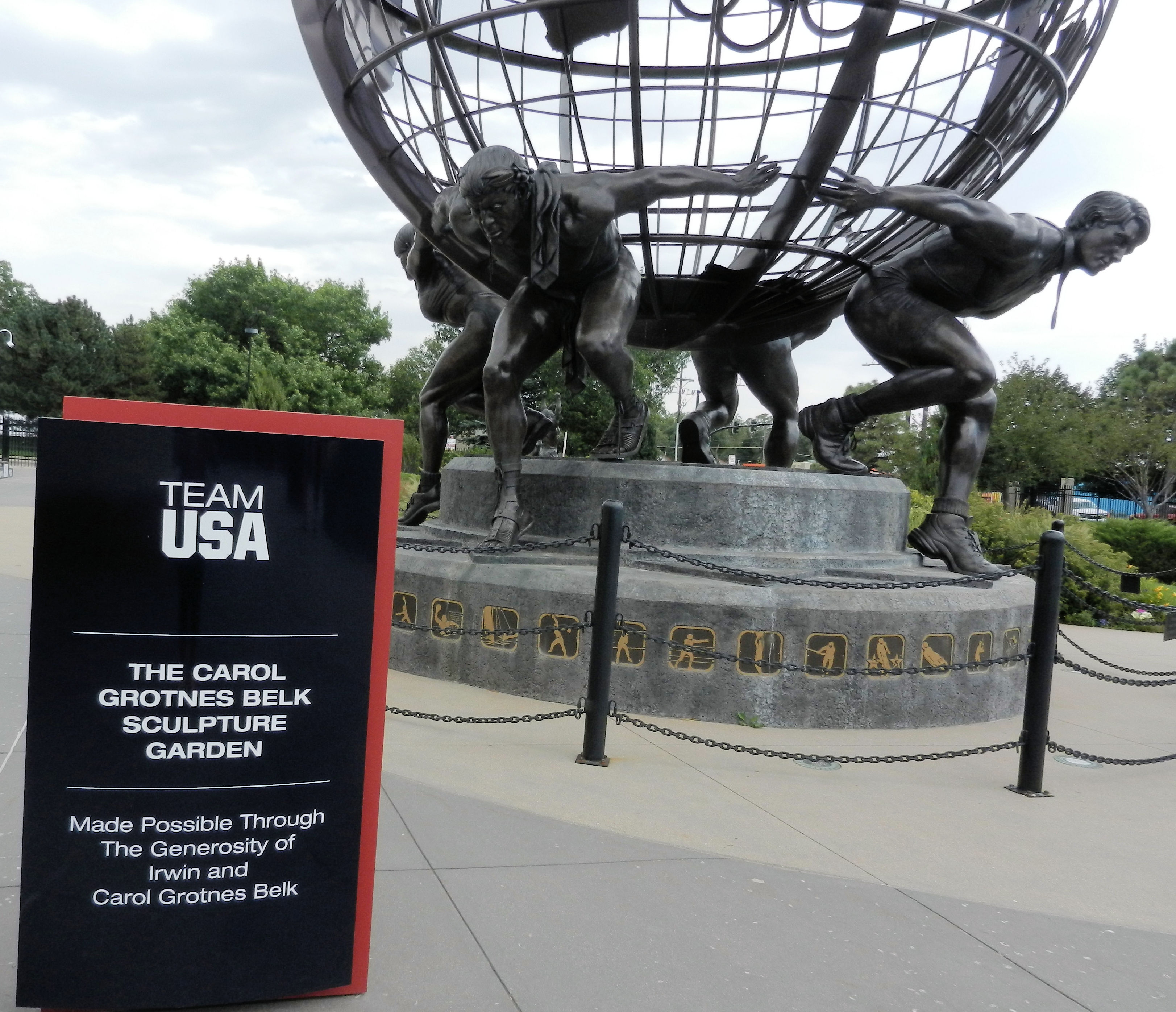 bronze globe supported on the backs of 4 athletes