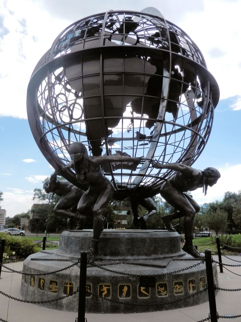 bronze globe supported on the backs of 4 athletes