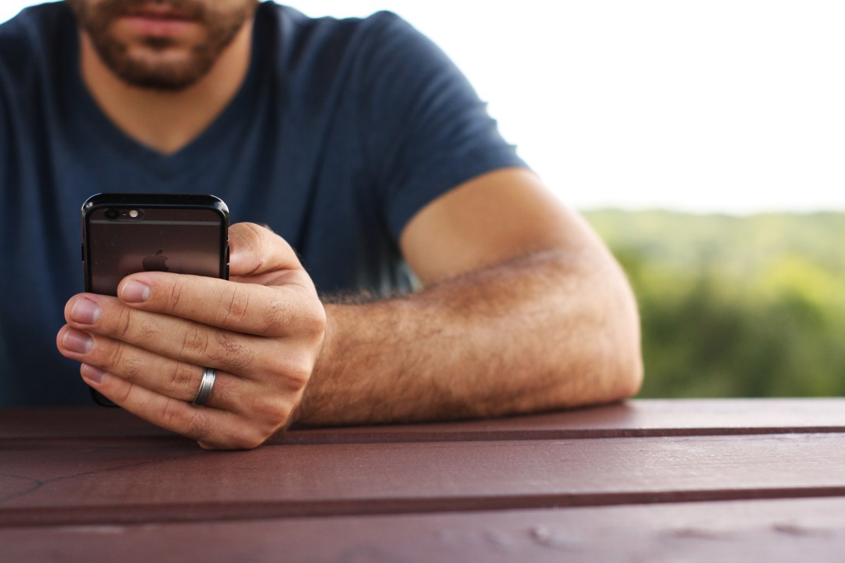 man looking at a phone screen